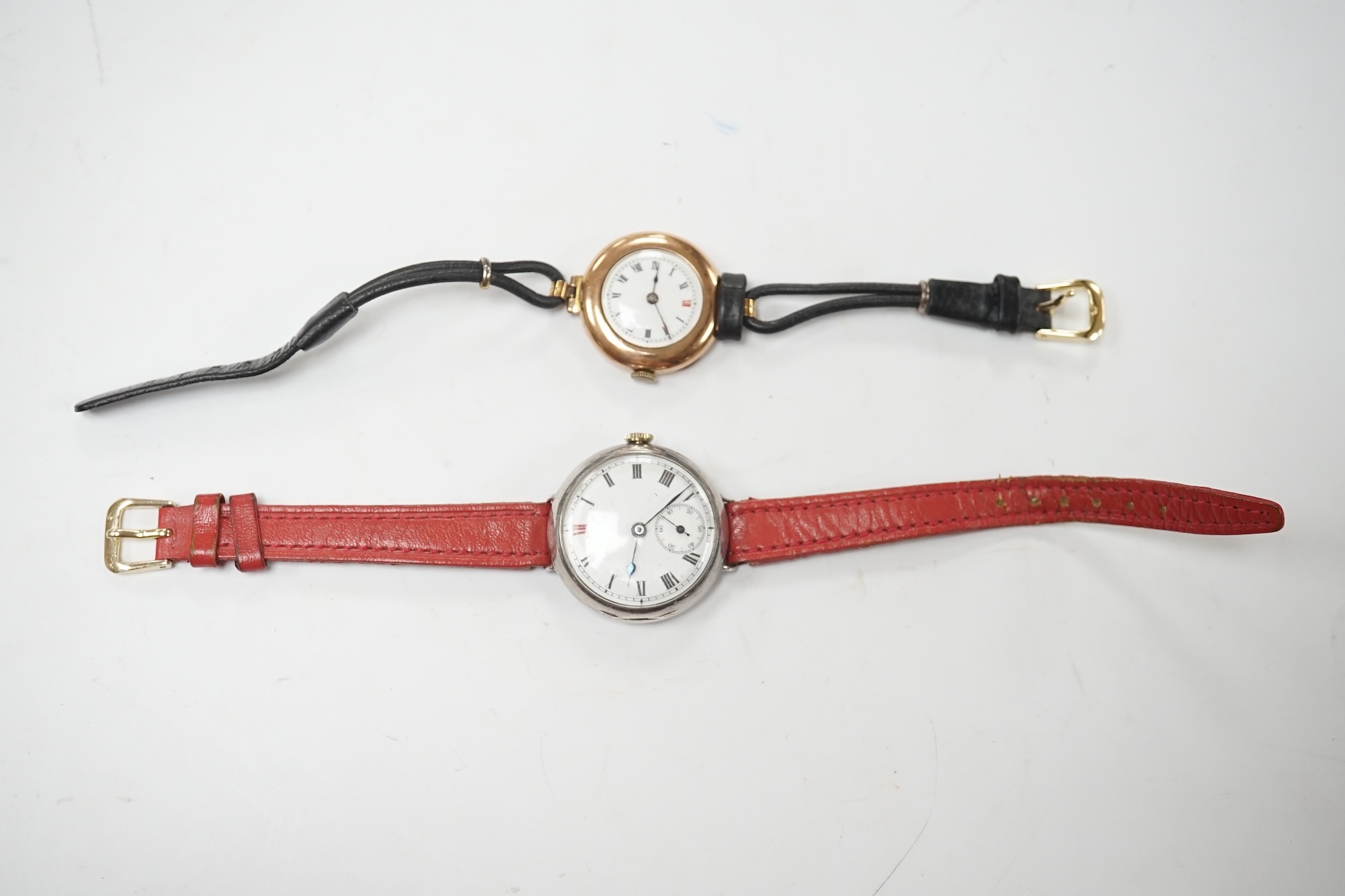 A George V 9ct gold manual wind wrist watch, with Roman dial, case diameter 27mm and a similar silver manual wind wrist watch. Condition - poor to fair